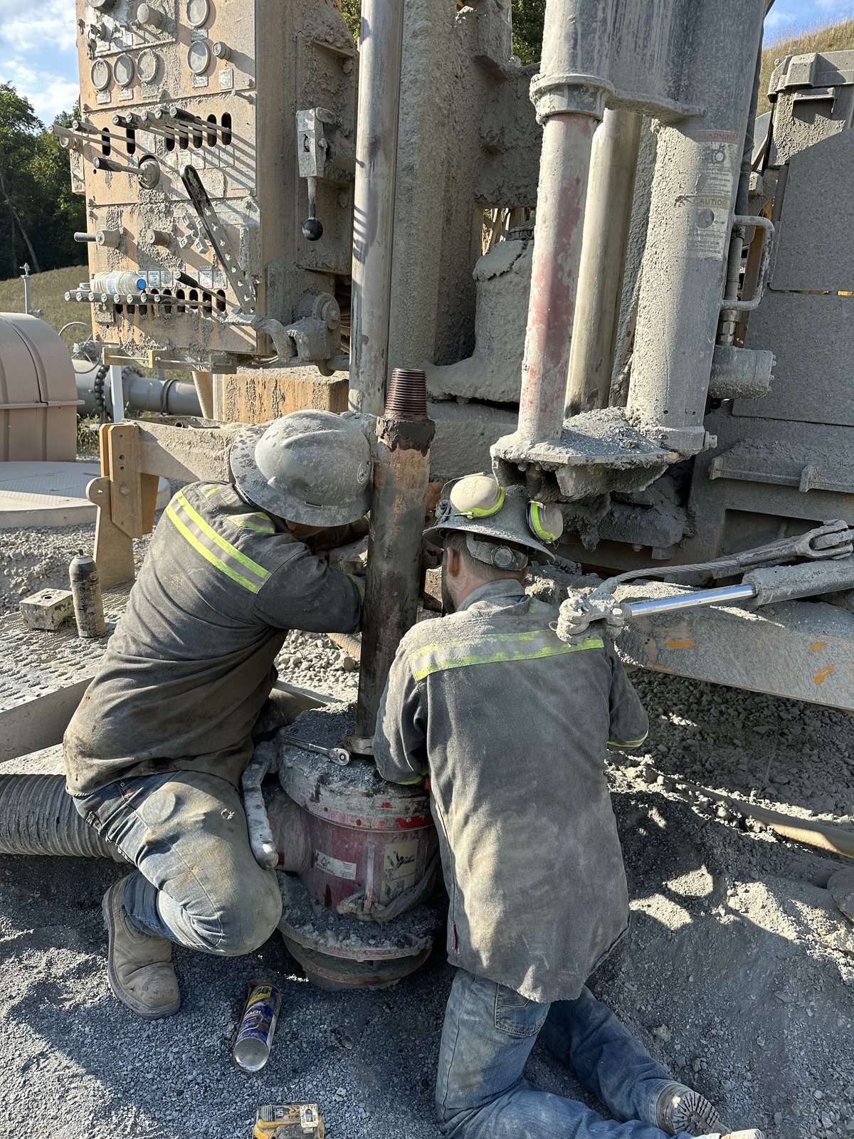 Two Roberts Corrosion Services technicians in the field working on a drill rig